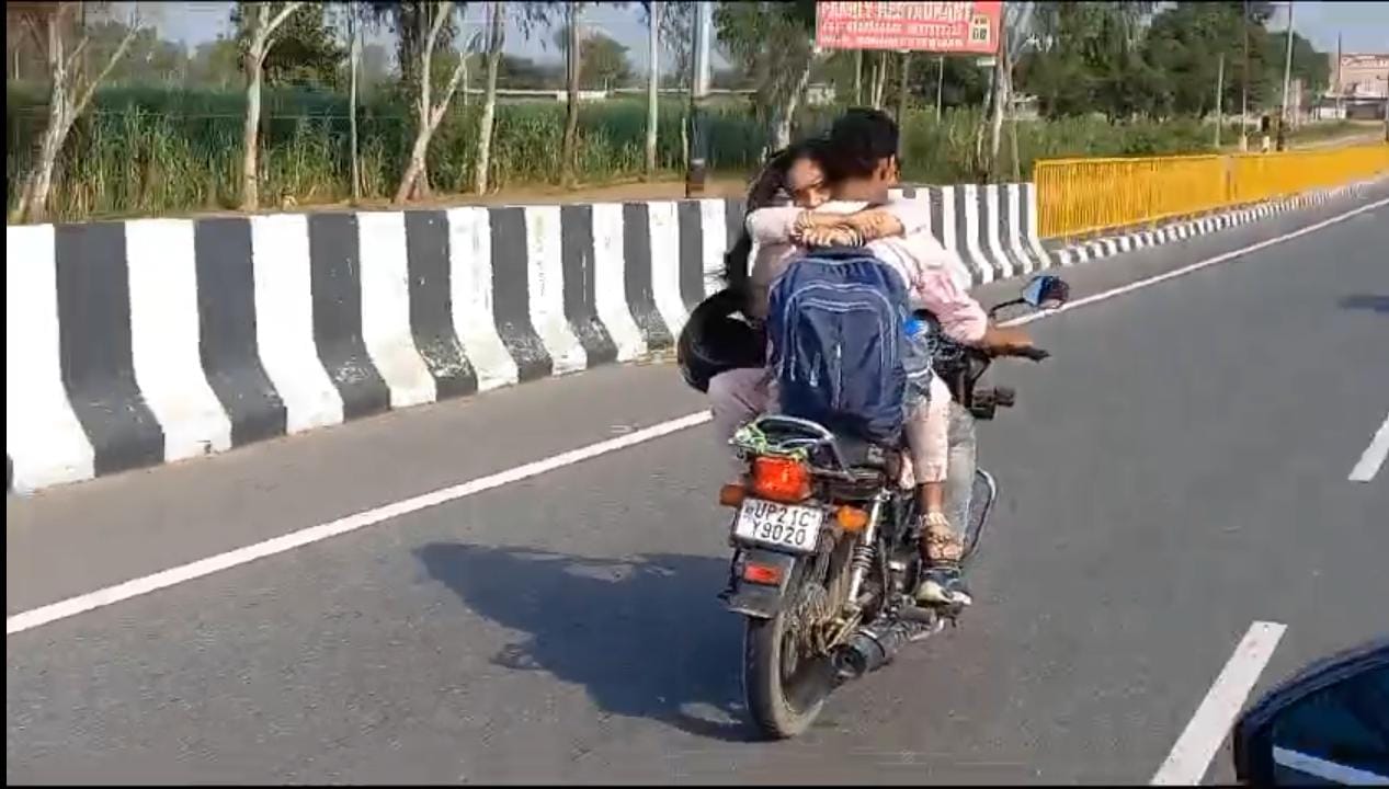 Couple seen romancing on bike in filmy style